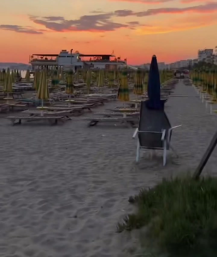 Sunset over a beach with closed parasols on the Albanian coast